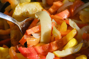 Fresh frying vegetables in a frying pan, close up. Shallow depth field