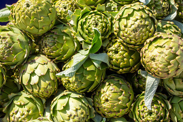 Green fresh organic artichoke in bazaar. Can be used as background texture.