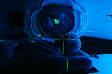 A patient undergoing radiation therapy. Medical linear accelerator in therapeutic oncology. The...