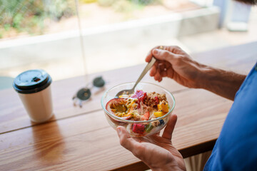 Indulge in a Vibrant and Healthy Breakfast Bowl While Enjoying Your Coffee in a Modern Cafe Setting