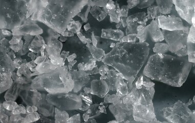 High-Resolution Microscopic Close-Up of Translucent Salt Crystals with Jagged Edges and Reflective...