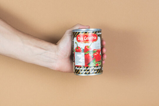 Hand holding a can of Don Celorio peppers showcasing vibrant colors and design, emphasizing culinary creativity concept