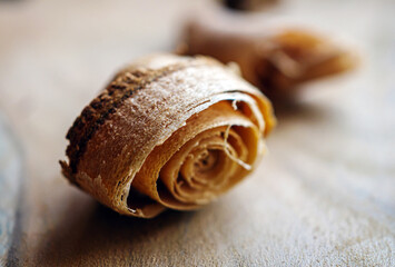 Wood shavings close-up against the background of other shavings and sawdust.