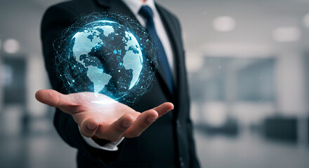 A businessman in a suit holds a glowing digital globe in his hand, symbolizing global connectivity.