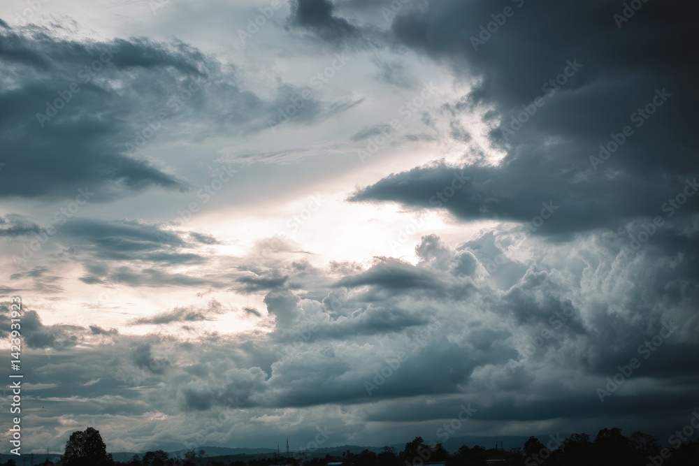 Wall mural dramatic overcast sky with gray clouds forming moody and tranquil backdrop before rain, capturing th