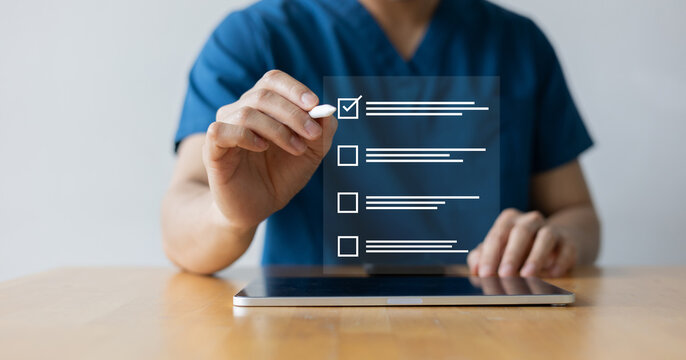 close up young general practitioner hand use stylus pen to check box on medical chekclist or opd record to read and diagnose and assess about patient's symptom for healthy and lifestyle concept