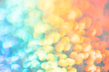 Abstract rainbow background. Beautiful multicolored bokeh. The backdrop is made of shiny sequins. Sparkling magical dust particles