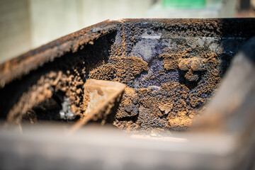 Carbon and resin inside the fireplace stove after the heating season. Cleaning the stove from carbon and maintenance in the spring