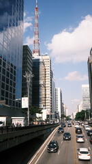 Avenida Paulista street view with ongoing and incoming traffic, capturing the pulse of São Paulo's...