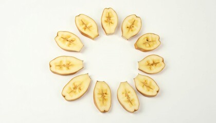 Sliced bananas arranged in a circular pattern on a white background, showcasing freshness and simplicity