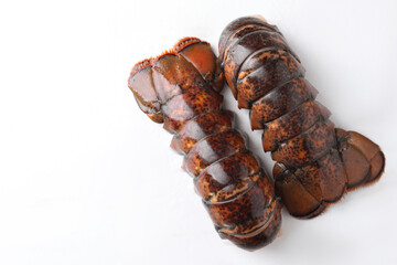 Raw lobster tails on white table, flat lay. Space for text