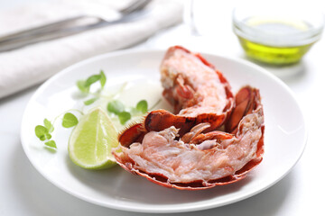 Delicious boiled lobster served on white table, closeup