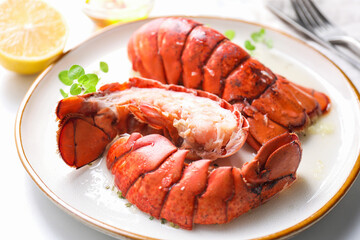 Delicious tails of boiled lobsters served on white table, closeup