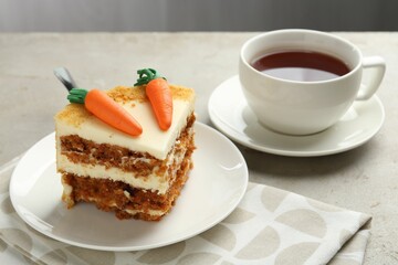 Piece of delicious homemade carrot cake served on light grey table