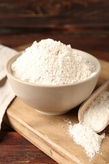 Brown rice flour on wooden table, closeup