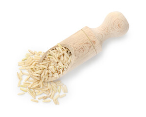 Raw brown rice and scoop isolated on white, top view
