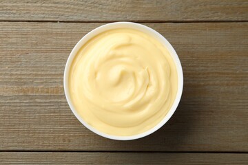 Tasty vanilla pudding on wooden table, top view