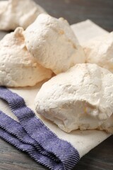 Delicious homemade meringue cookies on wooden table, closeup