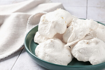 Delicious homemade meringue cookies on table, closeup