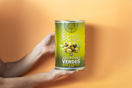 Green olives in a can held by hands, Campos de Almaz brand, showcasing healthy snacking options and Mediterranean cuisine concept
