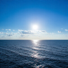 Obraz premium Serene Seascape at Sunset with Calm Ocean Waves, Golden Sunlight, and Clear Blue Sky – Tranquil Beach Scene for Relaxation