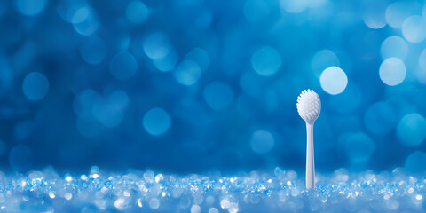 White Toothbrush on Blue Bokeh Background

