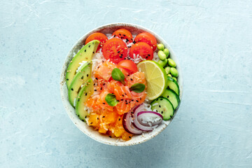 Poke bowl with salmon. Hawaiian salad with rice, fish, tomato, and avocado. Healthy diet. Overhead flat lay shot