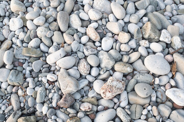 Smooth Gray and White Pebbles on Rocky Beach – Natural Background of Round Stones and Coastal Texture for Nature, Relaxation, and Design Concepts. High quality photography