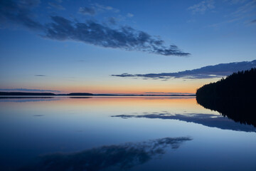 Landscape white nights on the lake with mirror reflections