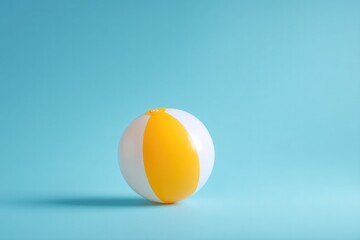 single beach ball sits on pastel blue background