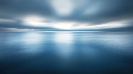 Calm, reflective ocean under a dramatic sky.