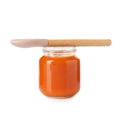 Baby food. Tasty puree in glass jar and spoon isolated on white