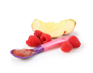 Baby food. Tasty puree in spoon, apple and raspberries isolated on white