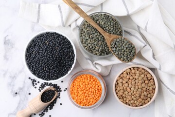 Different types of lentils on white table, flat lay