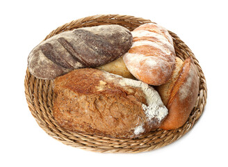 Different loaves of fresh bread in basket isolated on white, top view