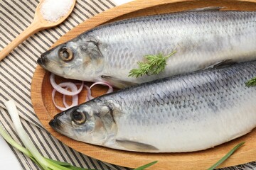 Salted herrings and spices on table, flat lay