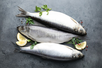 Salted herrings and spices on grey table, flat lay