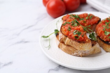 Tasty bread with tomatoes and parsley on white marble table, closeup. Space for text