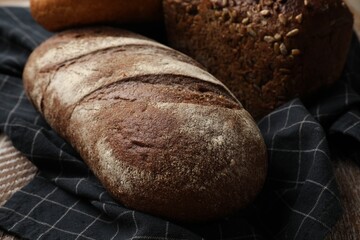 Different types of fresh bread on table, closeup