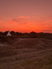 Fototapeta premium sunset over the tent and dunes
