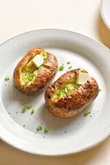 Baked filled potatoes with butter and green onion