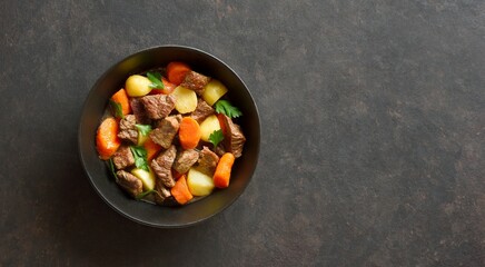 Beef stew with potatoes, carrots and greens