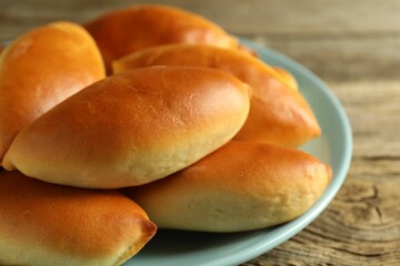 Tasty baked patties on wooden table, closeup