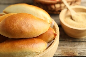 Tasty baked patties on wooden table, closeup
