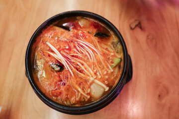 close up of spicy Korean kimchi tofu seafood soup in a pot