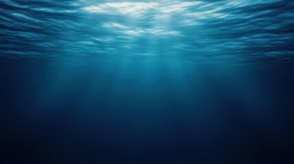 Obraz premium Deep ocean depths illuminated by sunlight.