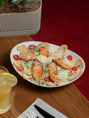 Chicken caesar salad plate on table