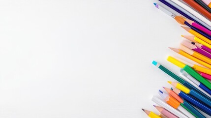 Fototapeta premium Colorful assortment of writing utensils arranged in a corner against a white background.