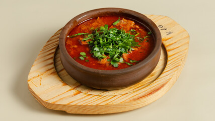 Borscht in ceramic pot isolated