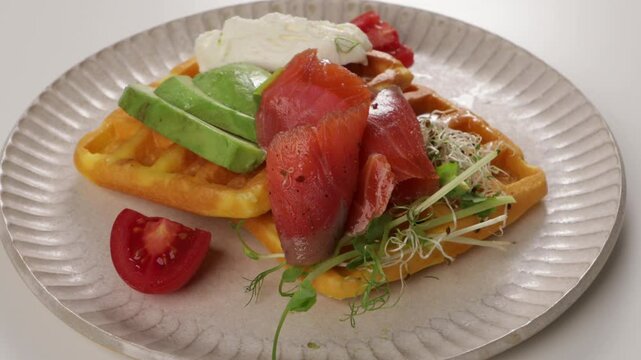 waffles with cheese and red fish slice on plate zoon food